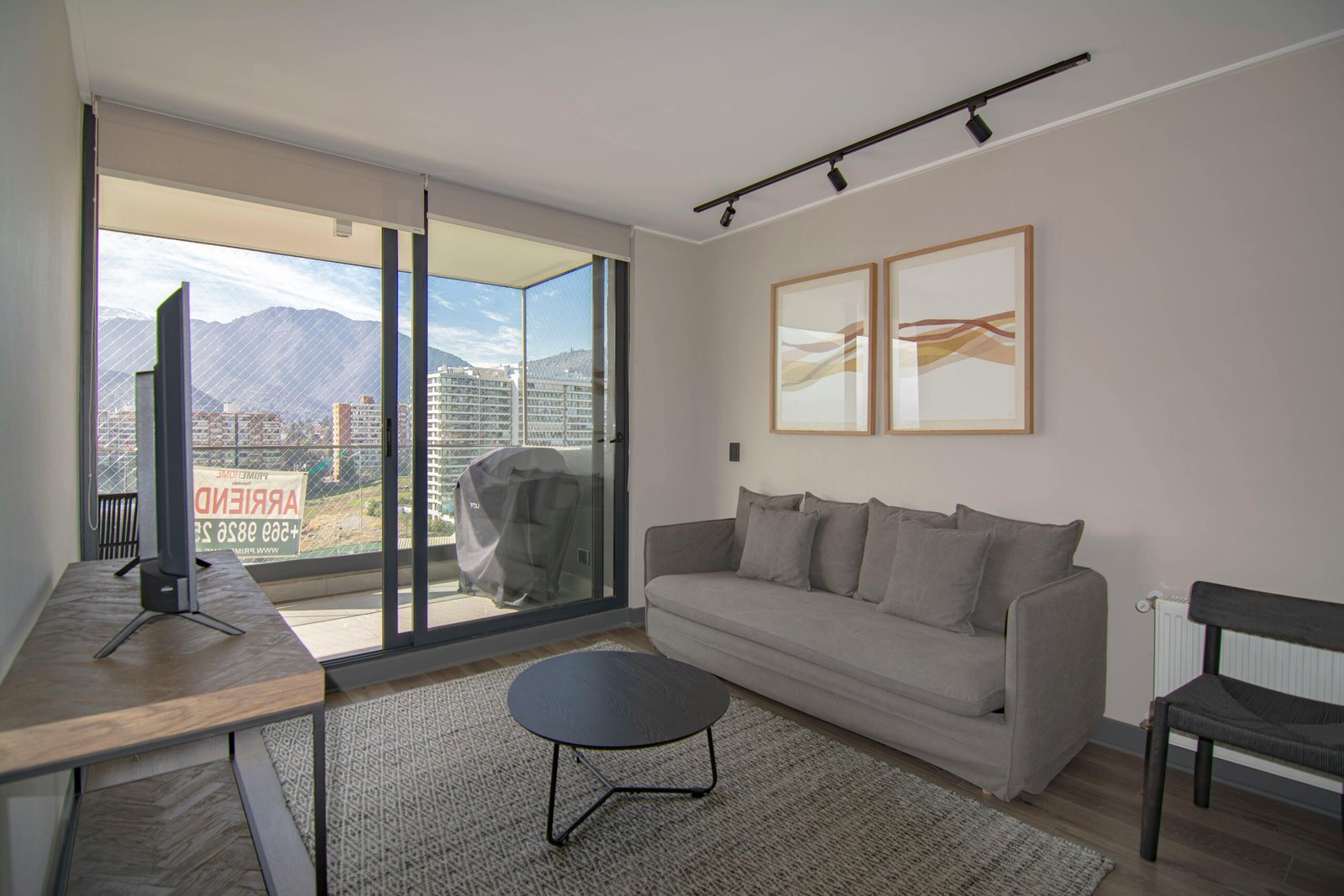 Contemporary living room featuring a cozy sofa, stylish decor, and stunning mountain view.